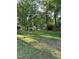 Lush backyard featuring a wooden swing set and dock access to the serene lake at 4117 Stansted Dr, Fuquay Varina, NC 27526