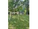 Lush backyard featuring a wooden swing set and dock access to the serene lake at 4117 Stansted Dr, Fuquay Varina, NC 27526