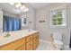 Bright bathroom with a double vanity, large mirror, and a window offering natural light at 4117 Stansted Dr, Fuquay Varina, NC 27526