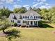 Beautiful two-story home with a lush green lawn, mature trees, and a charming front porch at 4117 Stansted Dr, Fuquay Varina, NC 27526