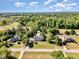 Beautiful home exterior surrounded by lush trees and greenery, with clear blue skies at 4117 Stansted Dr, Fuquay Varina, NC 27526