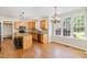 Bright kitchen with wooden cabinets, granite countertops, stainless steel appliances, and a breakfast bar at 4117 Stansted Dr, Fuquay Varina, NC 27526