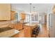 Open kitchen area with granite countertops, hardwood floors, a breakfast bar, and stainless steel appliances at 4117 Stansted Dr, Fuquay Varina, NC 27526