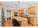 Eat-in kitchen boasting wooden cabinets, granite countertops, a breakfast bar, and stainless appliances at 4117 Stansted Dr, Fuquay Varina, NC 27526