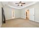 Neutral bedroom showing tray ceiling and a ceiling fan, offering a serene and relaxing space at 4117 Stansted Dr, Fuquay Varina, NC 27526