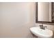 Charming powder room with a pedestal sink and ornate framed mirror reflecting the bright, neutral-toned space at 4117 Stansted Dr, Fuquay Varina, NC 27526
