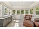 Sunroom with tiled floors, a leather chair and ottoman, lots of natural light, and outdoor views at 4117 Stansted Dr, Fuquay Varina, NC 27526