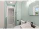 Bathroom featuring a tiled shower, modern fixtures, and a vanity sink at 413 Winterlochen Rd, Raleigh, NC 27603