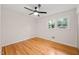 This bedroom features hardwood floors, neutral paint and a ceiling fan at 413 Winterlochen Rd, Raleigh, NC 27603