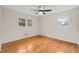 Bedroom featuring a ceiling fan, hardwood floors, and dual windows at 413 Winterlochen Rd, Raleigh, NC 27603