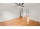 Bedroom with wood floors, ceiling fan, and mirrored closet at 413 Winterlochen Rd, Raleigh, NC 27603