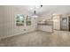 Dining area featuring classic chandelier, neutral color palette, and access to the kitchen, perfect for entertaining at 413 Winterlochen Rd, Raleigh, NC 27603