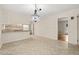 Charming dining room area featuring a chandelier and breakfast bar, connecting the kitchen and dining spaces at 413 Winterlochen Rd, Raleigh, NC 27603