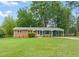 Lovely one-story brick home featuring manicured lawn and carport at 413 Winterlochen Rd, Raleigh, NC 27603