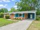 Charming brick home with a covered carport, front porch, and well maintained lawn at 413 Winterlochen Rd, Raleigh, NC 27603