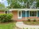 Charming single-story brick home with stylish blue accents at 413 Winterlochen Rd, Raleigh, NC 27603