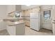This kitchen offers ample counter space and a white refrigerator at 413 Winterlochen Rd, Raleigh, NC 27603