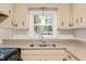 Kitchen sink with granite countertop and a window view, creating an appealing workspace at 413 Winterlochen Rd, Raleigh, NC 27603
