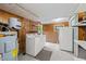 Spacious laundry room features washer, dryer, shelving and utility sink at 413 Winterlochen Rd, Raleigh, NC 27603