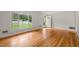 Bright living room with gleaming hardwood floors and a large window offering plenty of natural light at 413 Winterlochen Rd, Raleigh, NC 27603