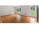Living room featuring wood floors, neutral walls, and natural lighting at 413 Winterlochen Rd, Raleigh, NC 27603