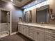 Elegant bathroom featuring double sinks, marble countertops, and a glass-enclosed shower at 4143 Gardenlake Dr, Raleigh, NC 27612
