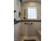 This tiled bathroom features a hand shower, safety bars, seat, and a window for great natural light at 4143 Gardenlake Dr, Raleigh, NC 27612
