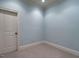 This bedroom has carpeted floors, a door, and large windows that provide great natural light at 4143 Gardenlake Dr, Raleigh, NC 27612