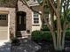 Inviting front entrance featuring a decorative glass door, brick steps, and lush landscaping at 4143 Gardenlake Dr, Raleigh, NC 27612