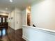 Elegant hallway with rich hardwood flooring, crown molding, and views of the home's interior at 4143 Gardenlake Dr, Raleigh, NC 27612