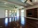 Bright and airy living room with hardwood floors, ceiling fans, and access to outdoor balcony at 4143 Gardenlake Dr, Raleigh, NC 27612