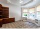 Bright living room featuring custom built-in shelves, recessed lighting, and large windows at 4143 Gardenlake Dr, Raleigh, NC 27612