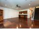 This living room features hardwood floors, recessed lighting, built in cabinets, a wet bar, and stairs at 4143 Gardenlake Dr, Raleigh, NC 27612