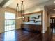 Elegant living room featuring dark hardwood floors, custom built-ins, and a modern chandelier at 4143 Gardenlake Dr, Raleigh, NC 27612