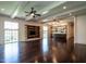 Open-concept living room featuring hardwood floors, modern lighting, and a built-in media center at 4143 Gardenlake Dr, Raleigh, NC 27612