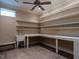 Well-organized storage room featuring a sink, ample shelving, workspace, and a ceiling fan for ventilation at 4143 Gardenlake Dr, Raleigh, NC 27612