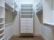 Organized walk-in closet with multiple shelves and drawers for storage at 4143 Gardenlake Dr, Raleigh, NC 27612