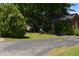 A charming front yard featuring unique metal art sculptures and a lush green lawn at 418 Madison Ave, Cary, NC 27513