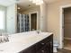 Bathroom with dual sinks, dark cabinets, and a large mirror at 43 Jonalker Ct, Clayton, NC 27520