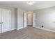 Bedroom with neutral carpet, white trim, and multiple doorways at 43 Jonalker Ct, Clayton, NC 27520
