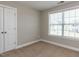 Empty bedroom with neutral walls, carpet flooring, and a closet at 43 Jonalker Ct, Clayton, NC 27520