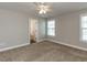 Bright bedroom with plush carpeting, neutral walls, a ceiling fan, and natural light from two windows at 43 Jonalker Ct, Clayton, NC 27520