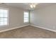 Well-lit bedroom featuring neutral walls, plush carpeting, and two large windows at 43 Jonalker Ct, Clayton, NC 27520