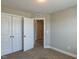 Bedroom with neutral carpet, white trim, closet, and white doors at 43 Jonalker Ct, Clayton, NC 27520