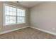 Neutral bedroom featuring carpet, window with blinds, and fresh paint at 43 Jonalker Ct, Clayton, NC 27520