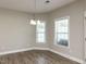Cozy dining area with modern chandelier lighting and natural light from the window at 43 Jonalker Ct, Clayton, NC 27520