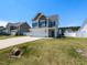 Beautiful two-story home with a well-kept lawn and a long driveway on a sunny day at 43 Jonalker Ct, Clayton, NC 27520