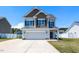 Charming two-story home with a two-car garage and well-manicured lawn under a clear blue sky at 43 Jonalker Ct, Clayton, NC 27520