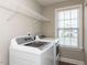 Well-lit laundry room with a modern washer and dryer and a window at 43 Jonalker Ct, Clayton, NC 27520