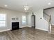 Comfortable living room with a fireplace, staircase, and hardwood floors at 43 Jonalker Ct, Clayton, NC 27520